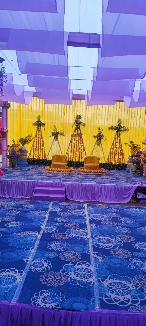 Haldi ceremony stage decorated with yellow florals and lavender fabric