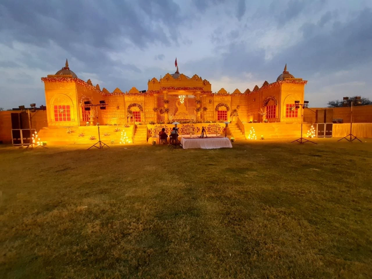 Illuminated royal wedding stage with ornate golden detailing